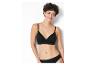 Une femme porte un soutien-gorge et une culotte noirs.