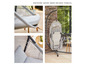 Un fauteuil suspendu gris avec un cadre métallique et un coussin beige.