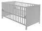 Lit bébé en bois blanc avec barreaux.