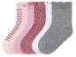 Un ensemble de six paires de chaussettes pour filles, avec des rayures, des pois et des couleurs unies.