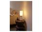 Lampe de table moderne avec abat-jour blanc laiteux sur une table en bois.