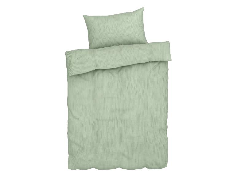 Parure de lit vert clair en mousseline de coton avec housse de couette et taie d'oreiller.