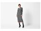 Femme en robe pull grise à manches longues, collants noirs et bottines noires.