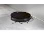 Un aspirateur robot Silvercrest noir sur un sol en carrelage gris.