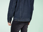 Une veste en jean bleu foncé et un jean noir.