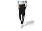 Pantalon de survêtement noir avec inscription 'WEDNESDAY' et baskets blanches.