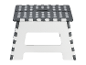 Tabouret pliable en plastique à pois gris et blancs.