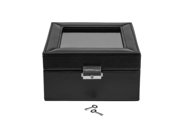 Une boîte à montre en cuir noir avec deux clés.