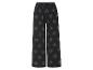 Pantalon large noir à motif feuilles.