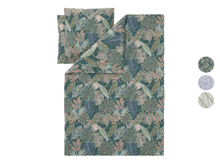 Parure de lit à motif de feuilles tropicales en vert foncé, marron et bleu.