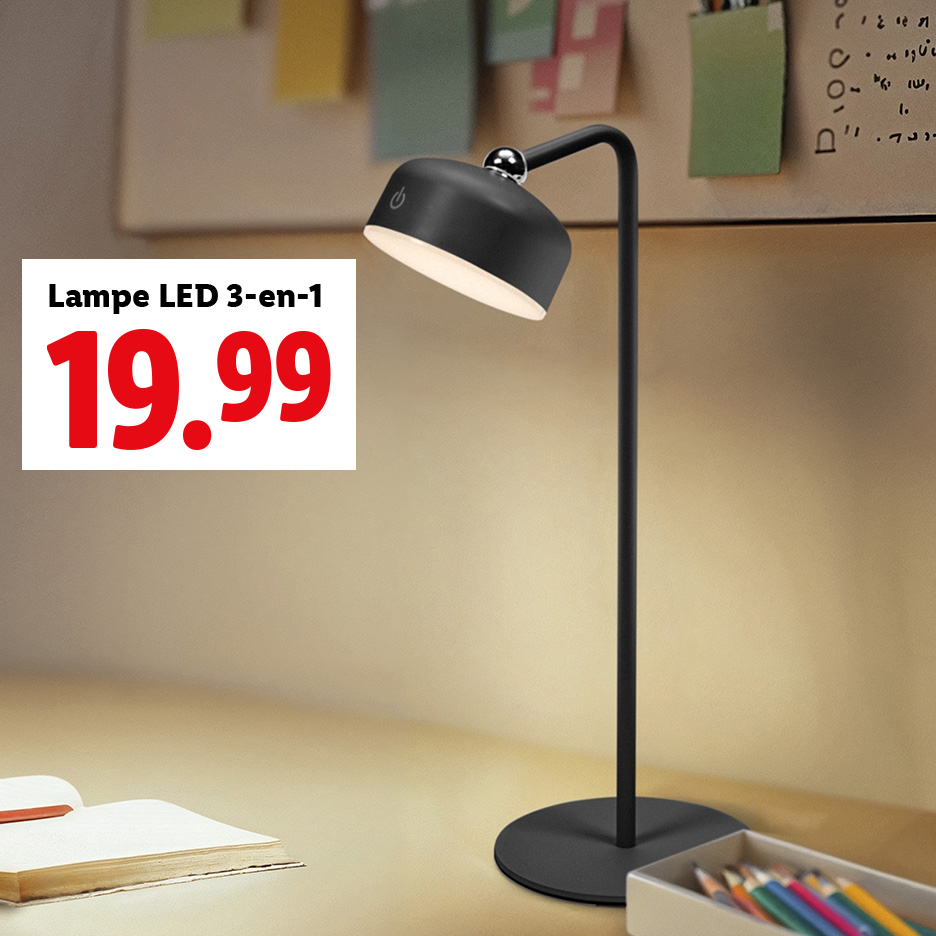 Lampe LED 3-en-1 noire sur un bureau avec un livre et des crayons.