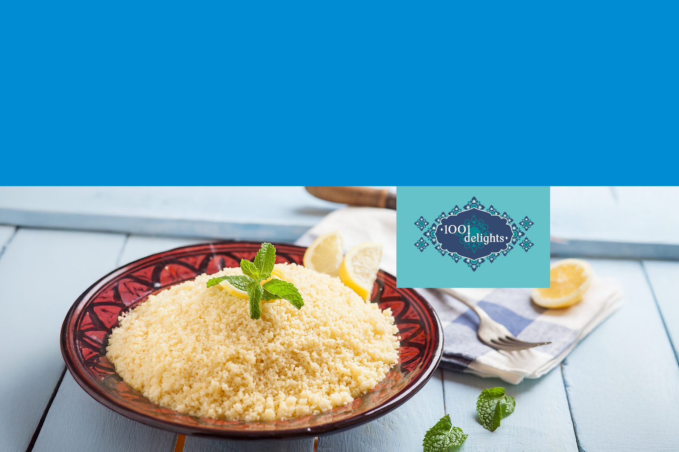 Couscous avec menthe et citron sur une table en bois bleu, avec un logo '1001 delights'.